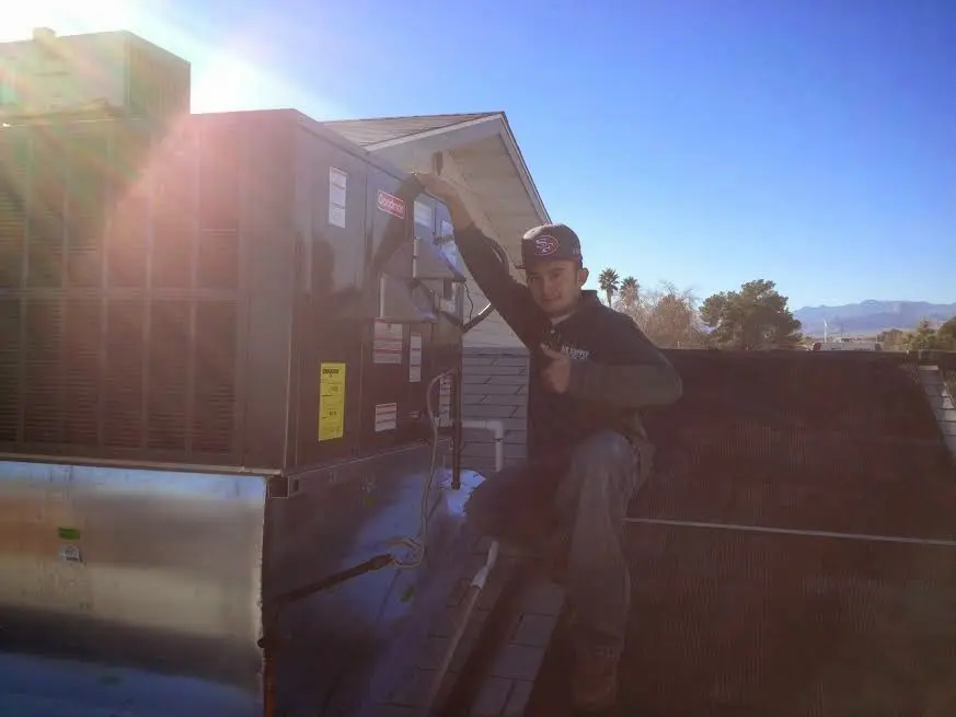 HVAC technician performing HVAC Inspection on a rooftop unit in Emeryville